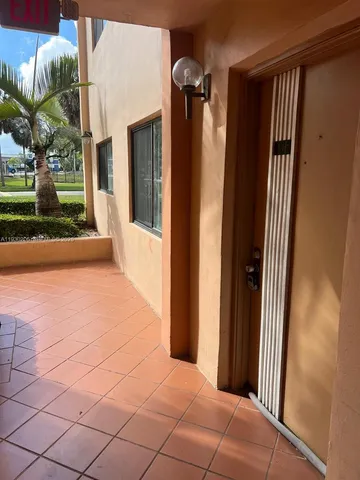 a kitchen with a sink a counter top space and stainless steel appliances