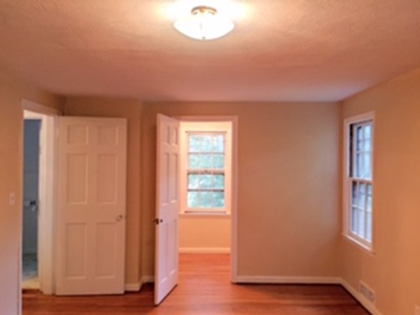 74 Rencelau Street Springfield, MA 01118 - Photo 14 of 21 an empty room with wooden floor and windows