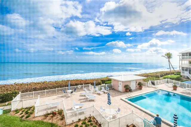 a view of a swimming pool with an outdoor seating