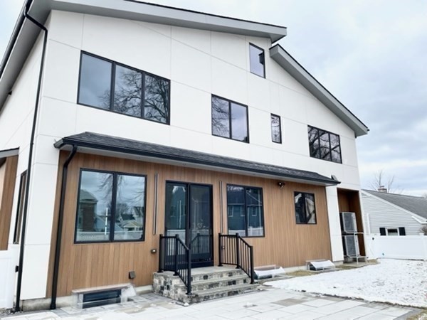 21 Tocci Path Newton, MA 02459 - Photo 2 of 24 a front view of a house with a porch
