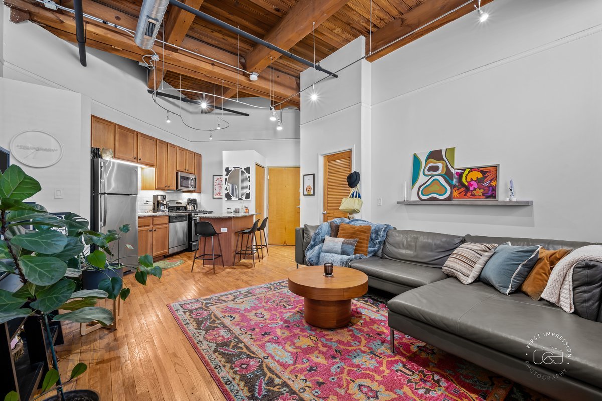 1500 West Monroe Street, Unit 409 Chicago, IL 60607 - Photo 12 of 20 a living room with furniture a rug and a chandelier
