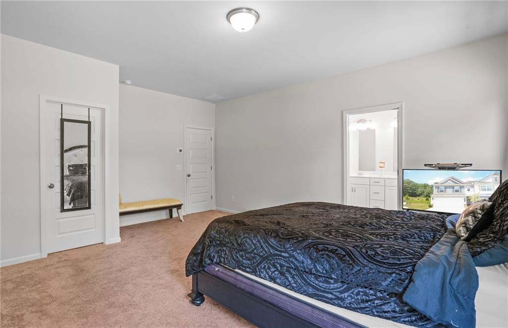 10 Kane Drive Jasper, GA 30143 - Photo 16 of 24 a bedroom with a large bed and a chandelier