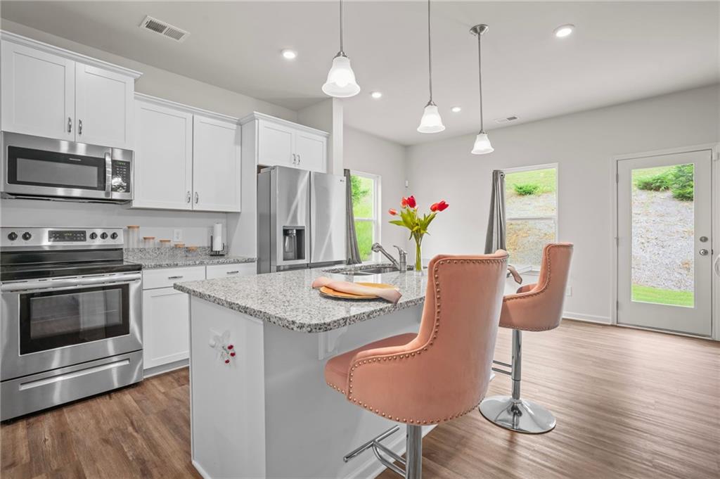 10 Kane Drive Jasper, GA 30143 - Photo 10 of 24 a kitchen with stainless steel appliances granite countertop a kitchen island hardwood floor sink stove dining table and chairs