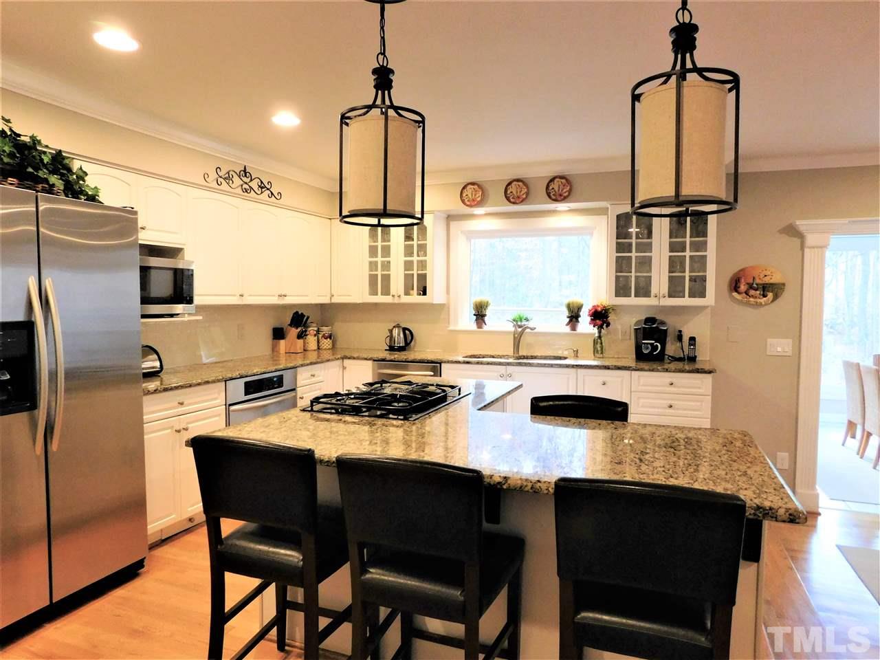 1308 Bascomb Drive Raleigh, NC 27614 - Photo 3 of 25 Kitchen w/island,Gas Cooktop,Updated Pendant Lighting,Hardwoods and Stainless Appliances!