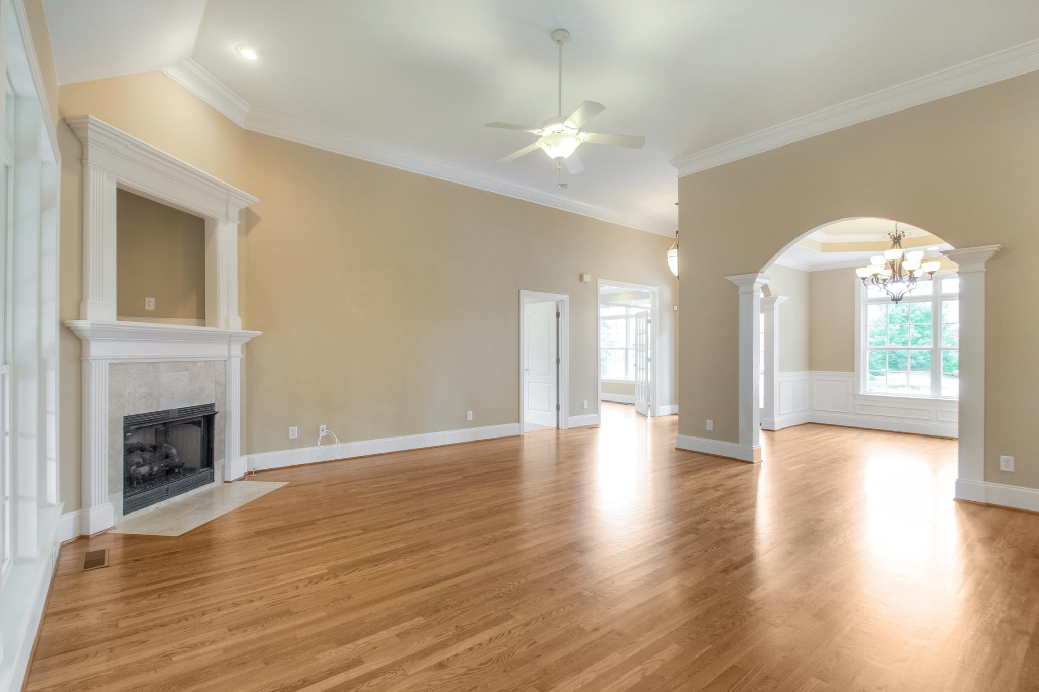 1631 Fair House Road Spring Hill, TN 37174 - Photo 11 of 29 a view of an empty room with wooden floor and a fireplace