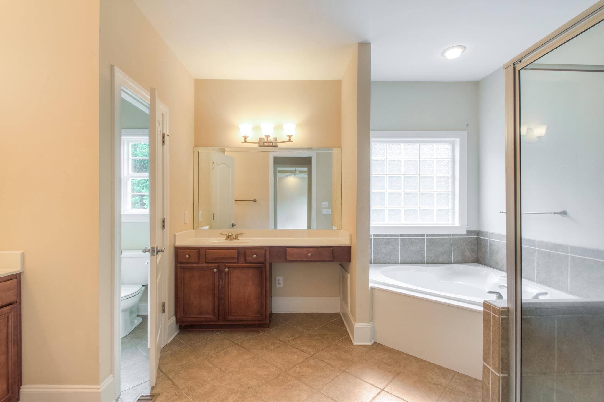 1631 Fair House Road Spring Hill, TN 37174 - Photo 19 of 29 a spacious bathroom with a tub sink and mirror