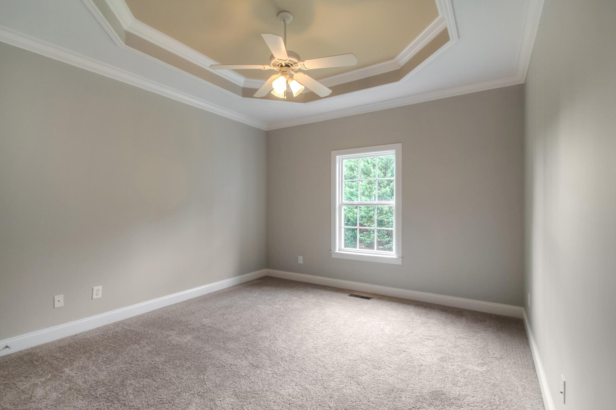 1631 Fair House Road Spring Hill, TN 37174 - Photo 23 of 29 an empty room with a chandelier fan and windows