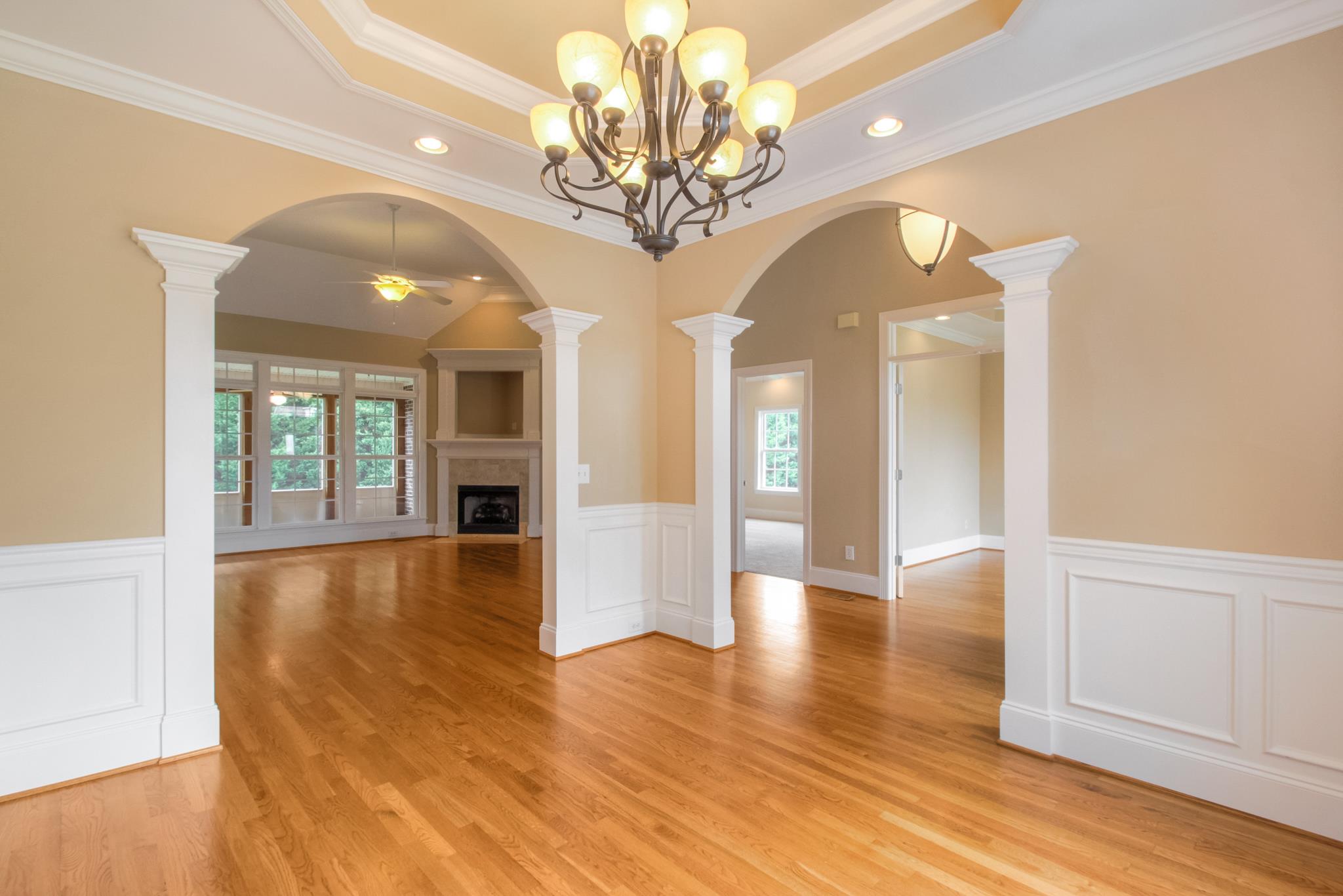 1631 Fair House Road Spring Hill, TN 37174 - Photo 6 of 29 a view of an empty room with wooden floor and a kitchen