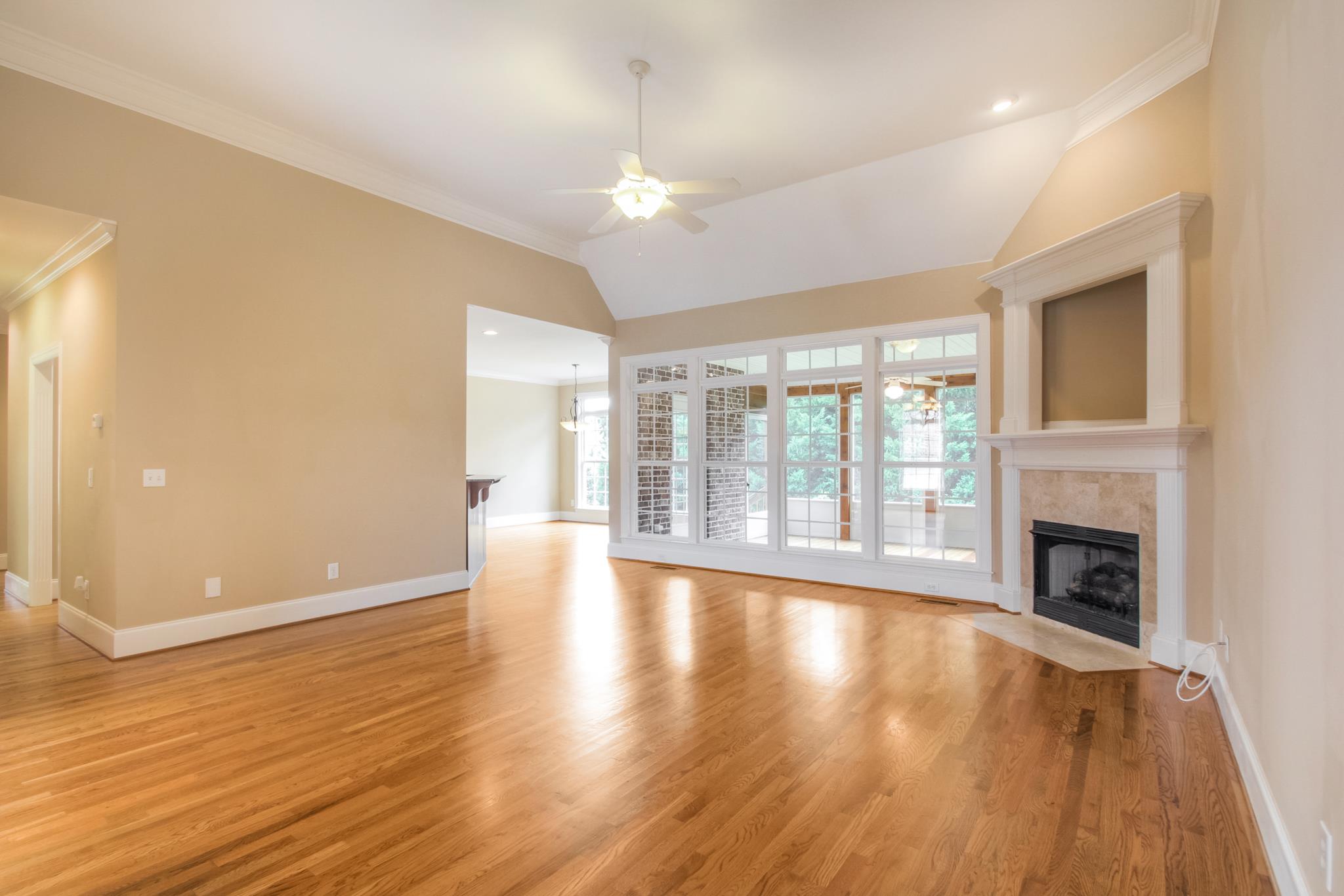 1631 Fair House Road Spring Hill, TN 37174 - Photo 9 of 29 a view of an empty room with wooden floor and a fireplace