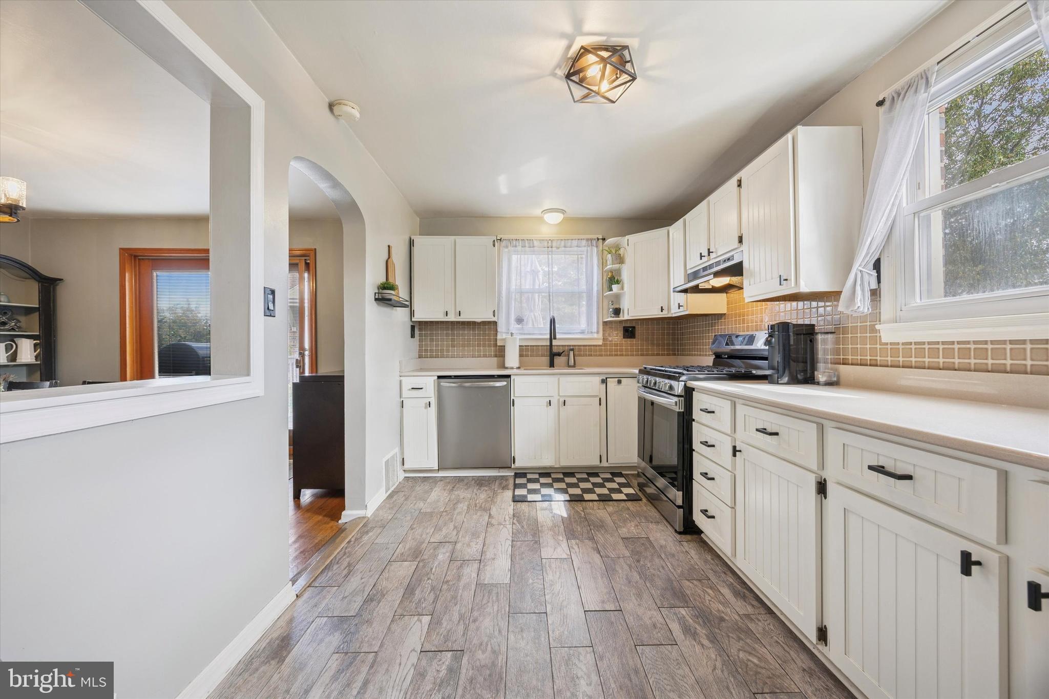 539 Overlook Road Philadelphia, PA 19128 - Photo 8 of 25 a kitchen with white cabinets and wooden floor