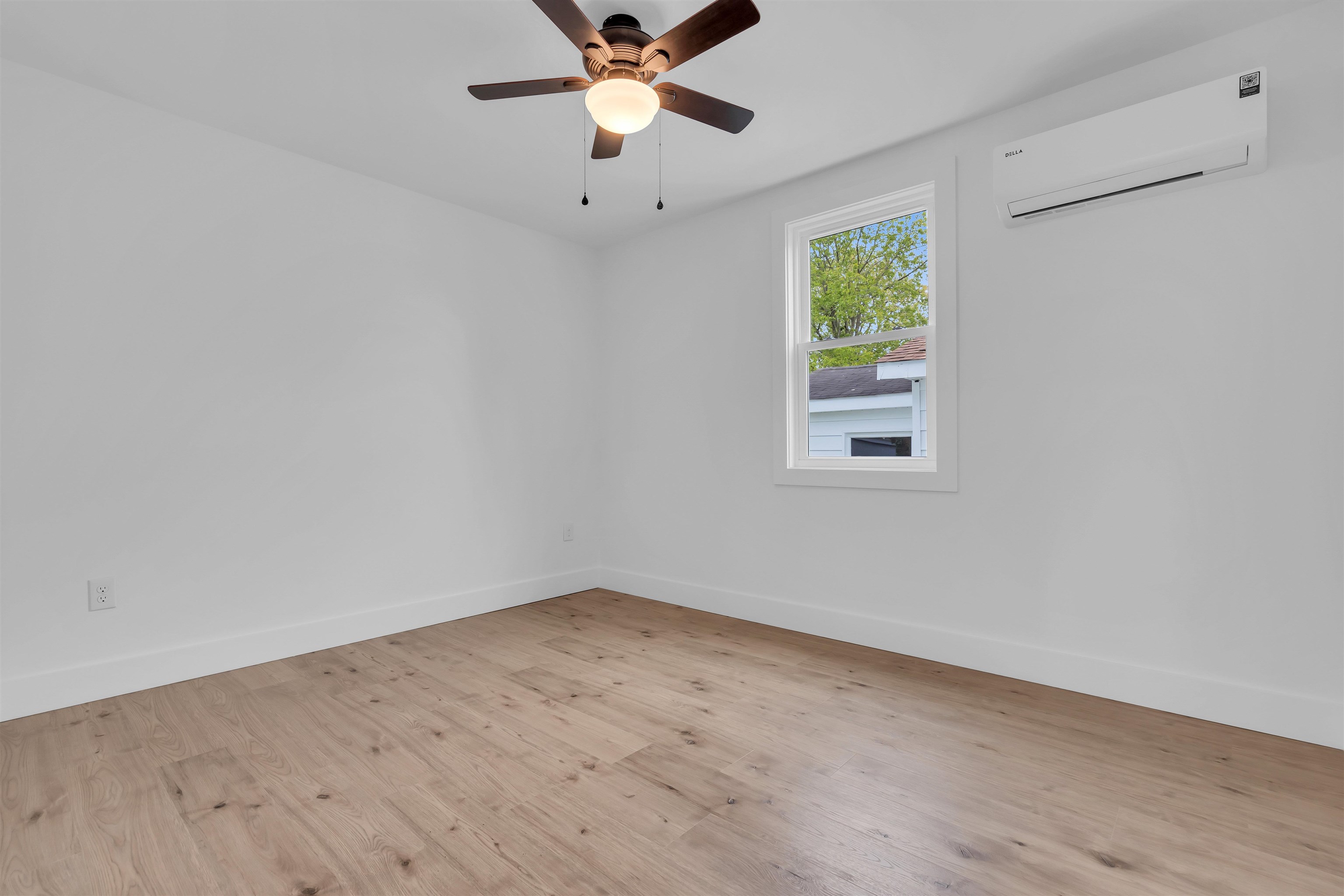 539 Seashore Road Erma, NJ 08204 - Photo 9 of 18 an empty room with wooden floor fan and windows