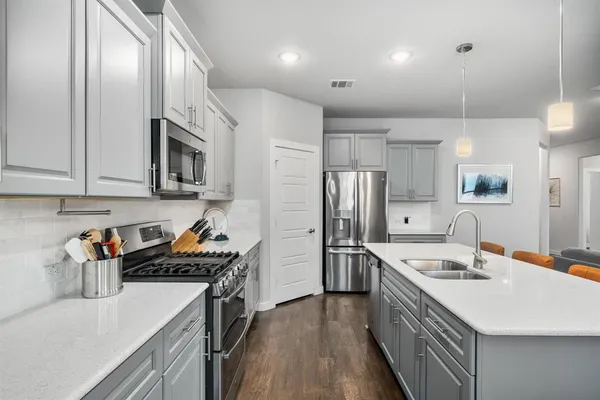 a kitchen with a sink a stove and refrigerator