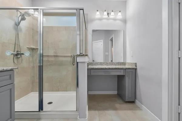 a bathroom with a shower sink and mirror