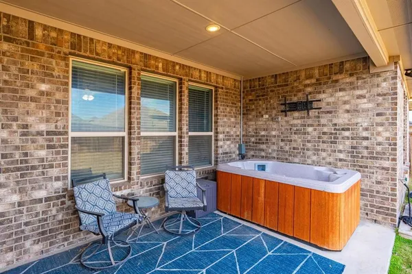 a view of a chair and table in the patio