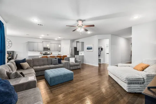 a living room with furniture and kitchen view