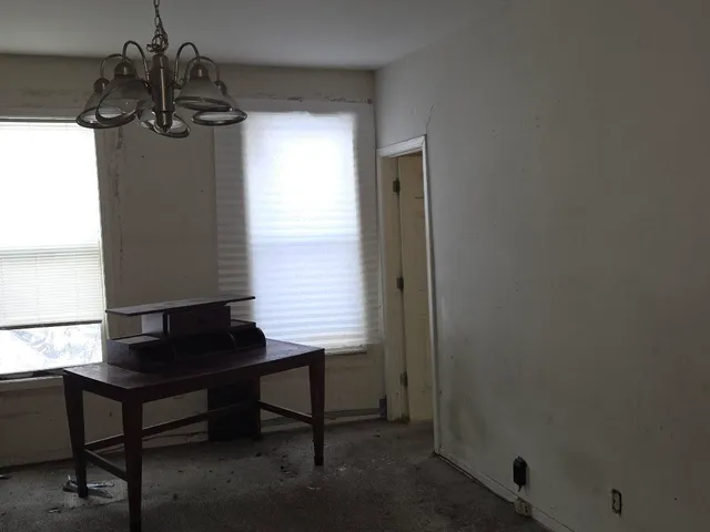 a dining room with furniture and window