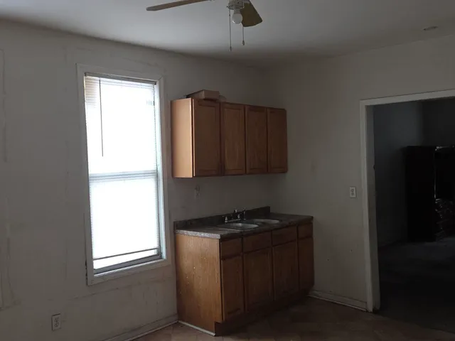 a kitchen with granite countertop cabinets appliances and a window