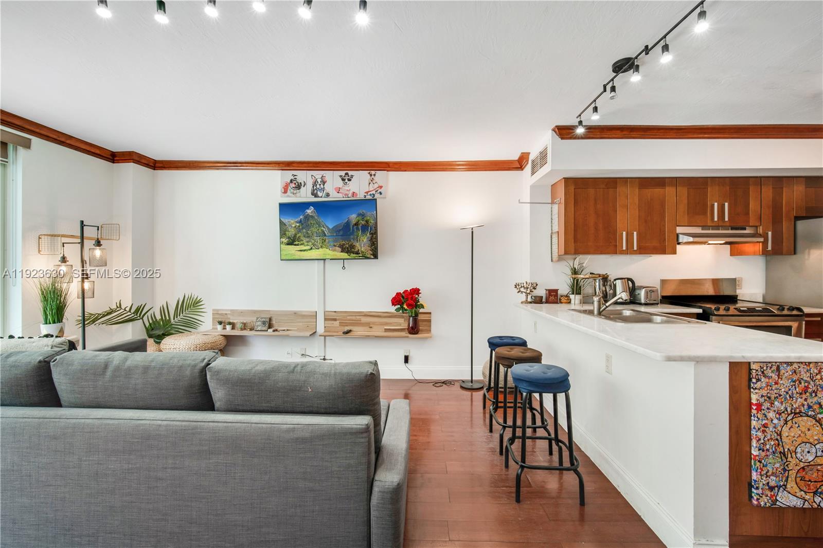 9499 Collins Avenue, Unit 1005 Surfside, FL 33154 - Photo 11 of 35 a living room with furniture and a wooden floor