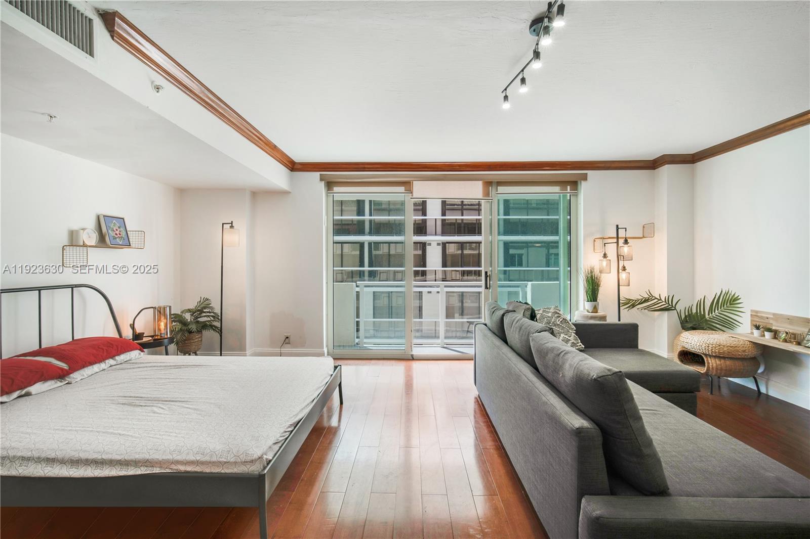 9499 Collins Avenue, Unit 1005 Surfside, FL 33154 - Photo 13 of 35 a living room with furniture and a large window