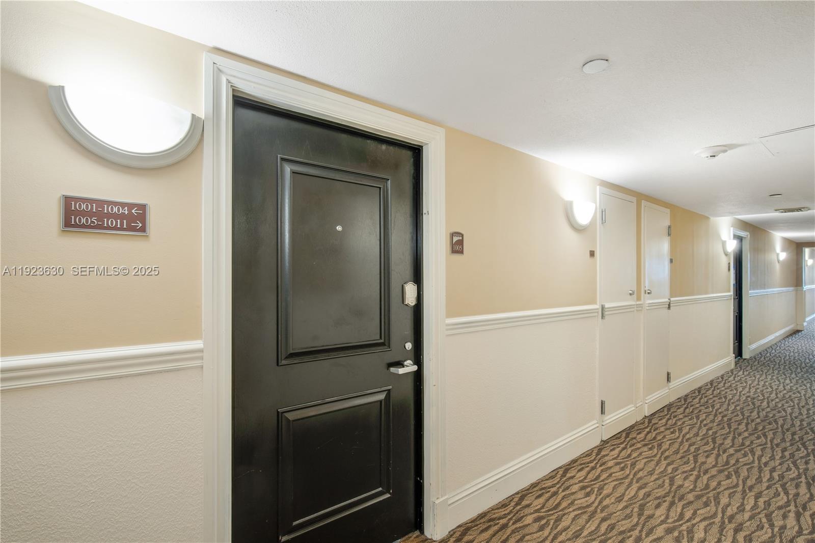 9499 Collins Avenue, Unit 1005 Surfside, FL 33154 - Photo 21 of 35 a view of a hallway with wooden floor