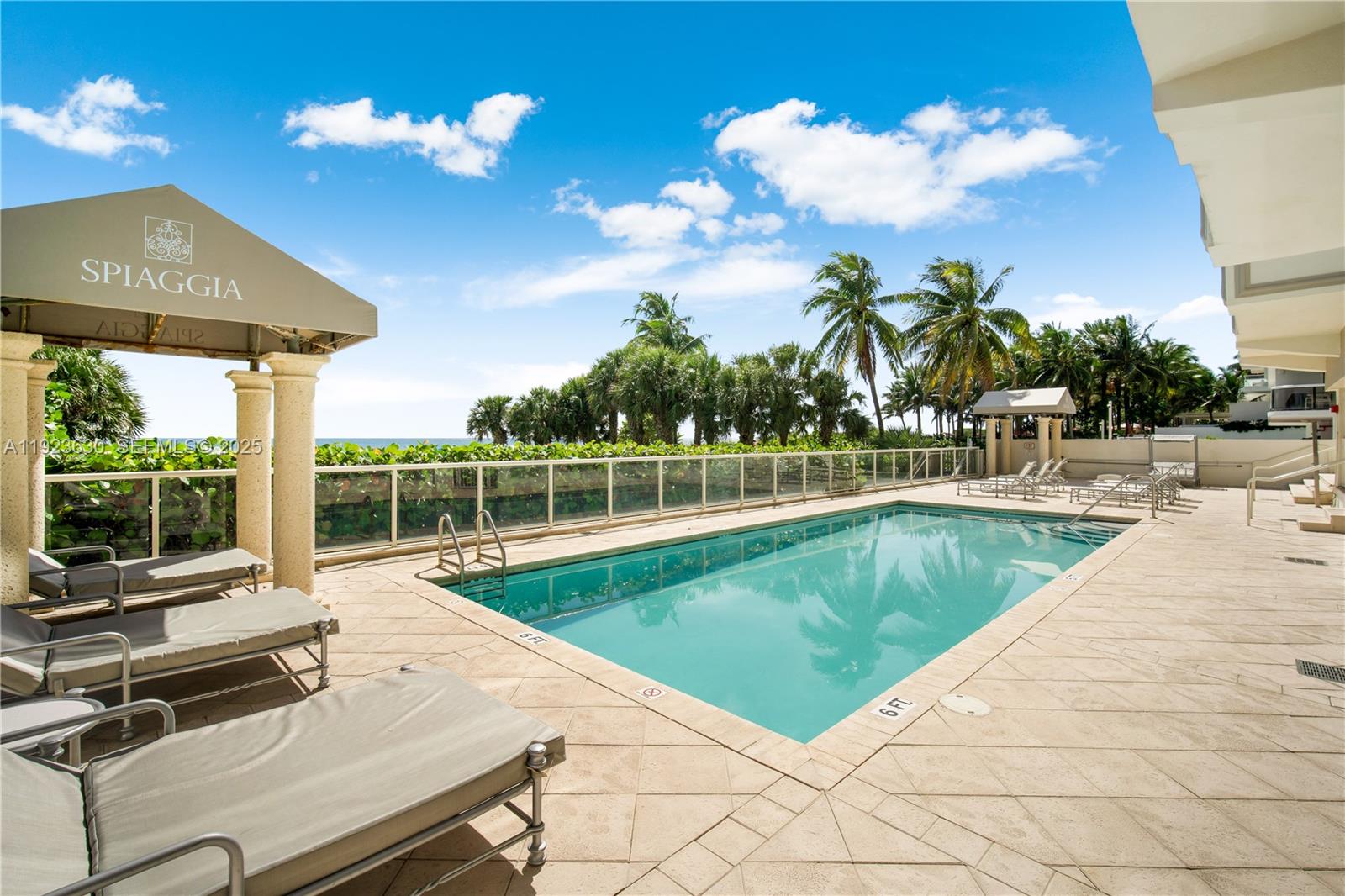9499 Collins Avenue, Unit 1005 Surfside, FL 33154 - Photo 23 of 35 a view of a swimming pool with a patio