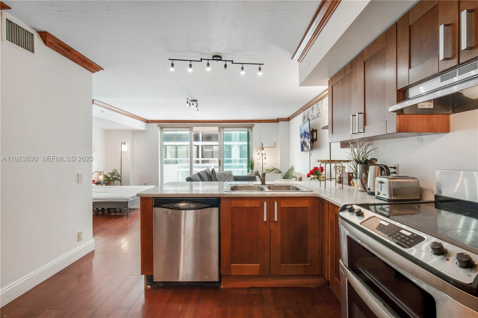 9499 Collins Avenue, Unit 1005 Surfside, FL 33154 - Photo 6 of 35 a kitchen with lots of counter top space and stove