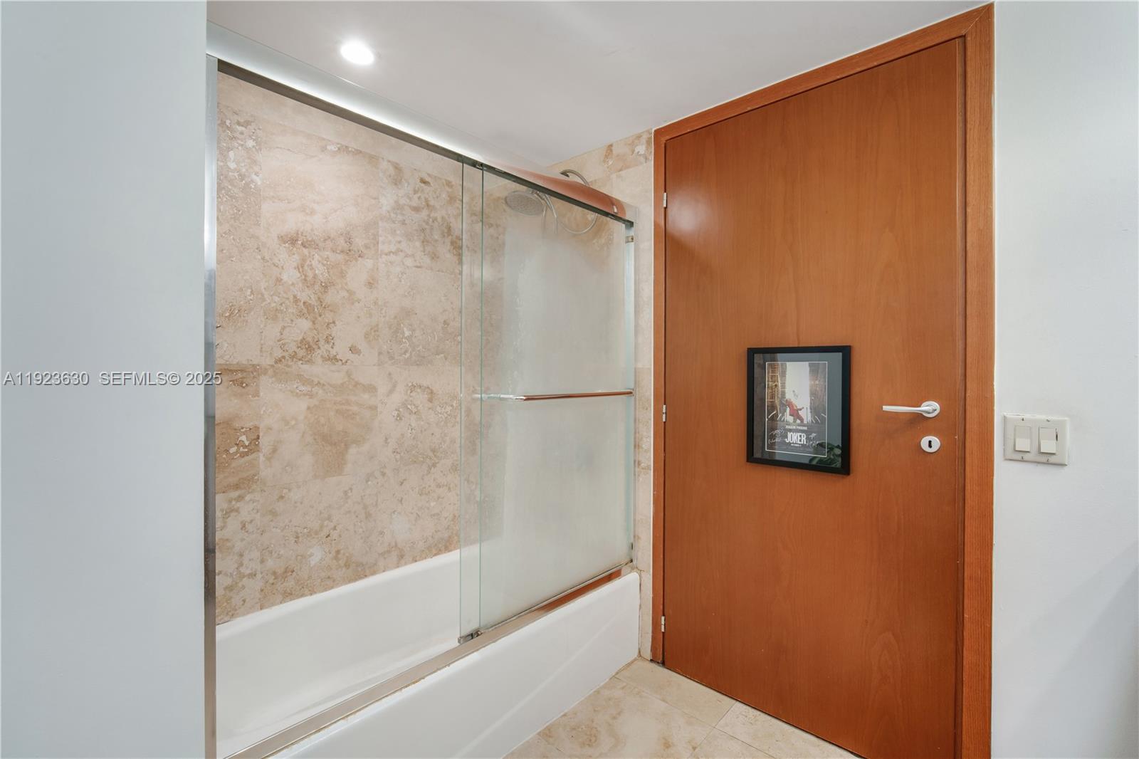 9499 Collins Avenue, Unit 1005 Surfside, FL 33154 - Photo 10 of 35 a bathroom with a bathtub and a shower