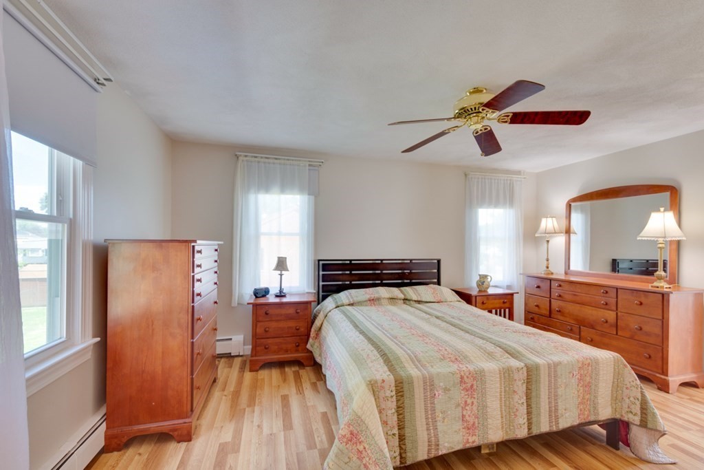 29 Anna Road Woburn, MA 01801 - Photo 11 of 29 a bedroom with a bed and a chandelier