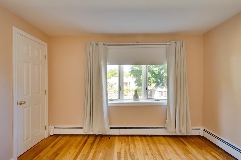 29 Anna Road Woburn, MA 01801 - Photo 17 of 29 an empty room with wooden floor and windows