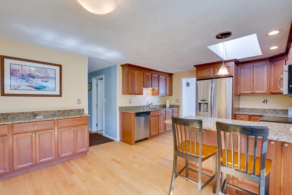 29 Anna Road Woburn, MA 01801 - Photo 2 of 29 a kitchen with stainless steel appliances granite countertop a stove a sink dishwasher a refrigerator and wooden cabinets with wooden floor