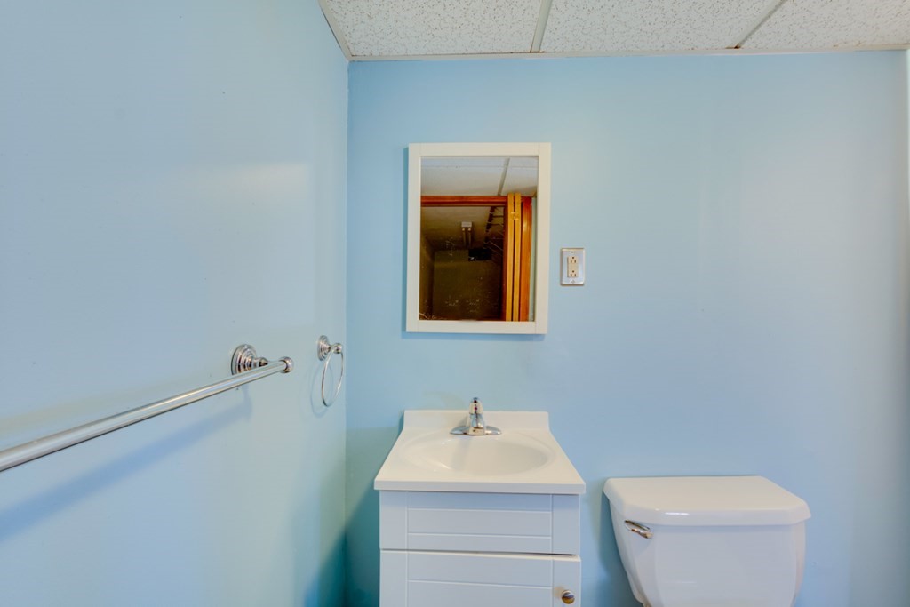 29 Anna Road Woburn, MA 01801 - Photo 23 of 29 a bathroom with a toilet sink and mirror