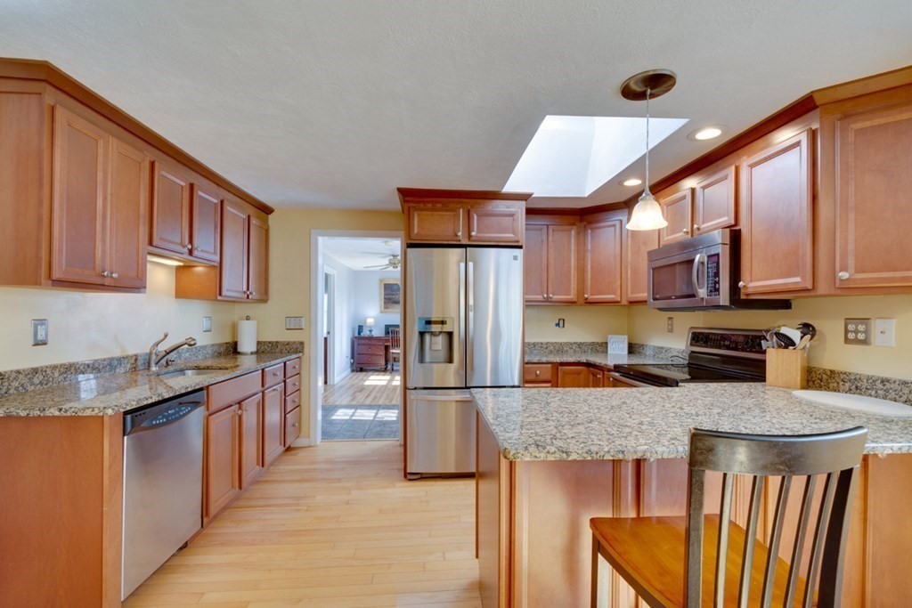 29 Anna Road Woburn, MA 01801 - Photo 3 of 29 a kitchen with stainless steel appliances granite countertop a refrigerator stove top oven a sink and dishwasher