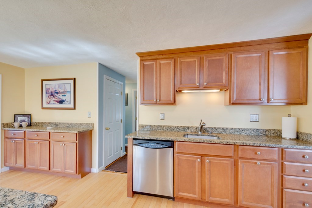 29 Anna Road Woburn, MA 01801 - Photo 6 of 29 a kitchen with stainless steel appliances granite countertop a stove a sink dishwasher and a refrigerator with wooden cabinets
