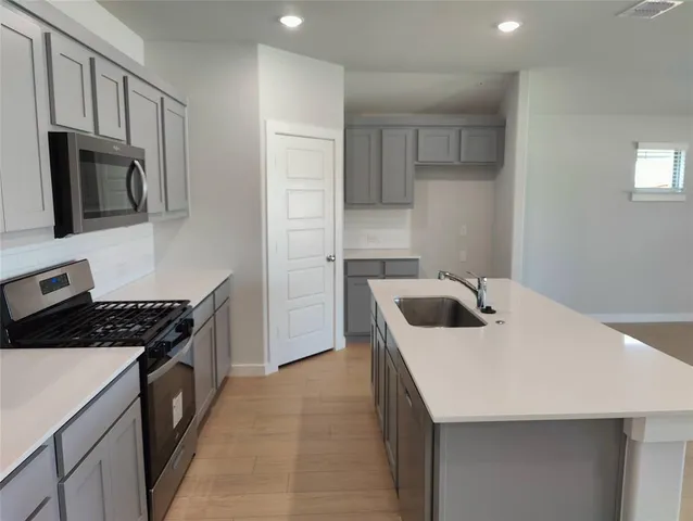 a kitchen with a sink a stove and refrigerator