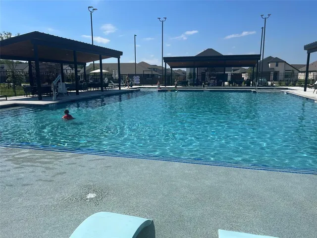 a view of a swimming pool and lounge chairs