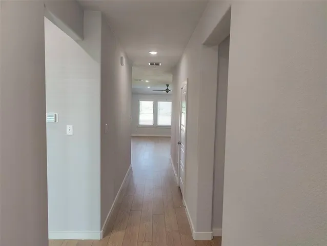 a view of hallway with wooden floor