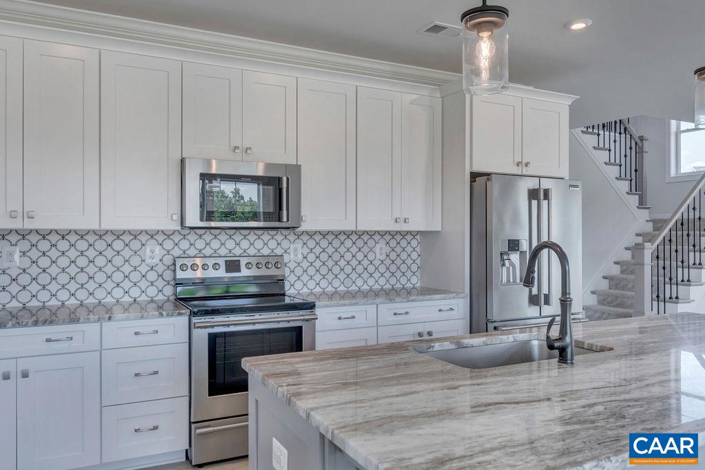 466 Claibourne Road Crozet, VA 22932 - Photo 13 of 39 a kitchen with granite countertop a sink stainless steel appliances and cabinets