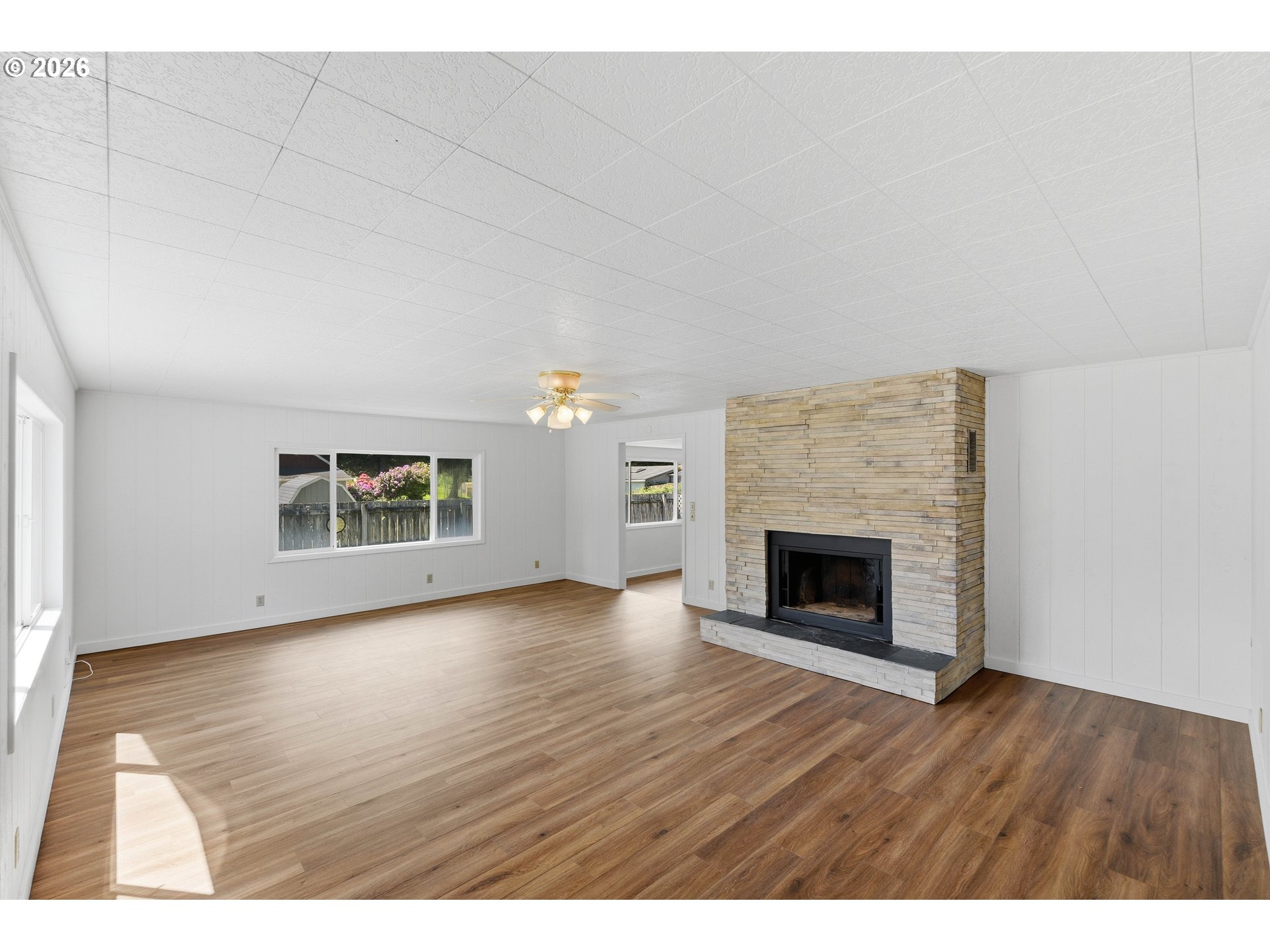 63299 Wildahl Road Coos Bay, OR 97420 - Photo 10 of 45 a view of empty room with wooden floor and fireplace