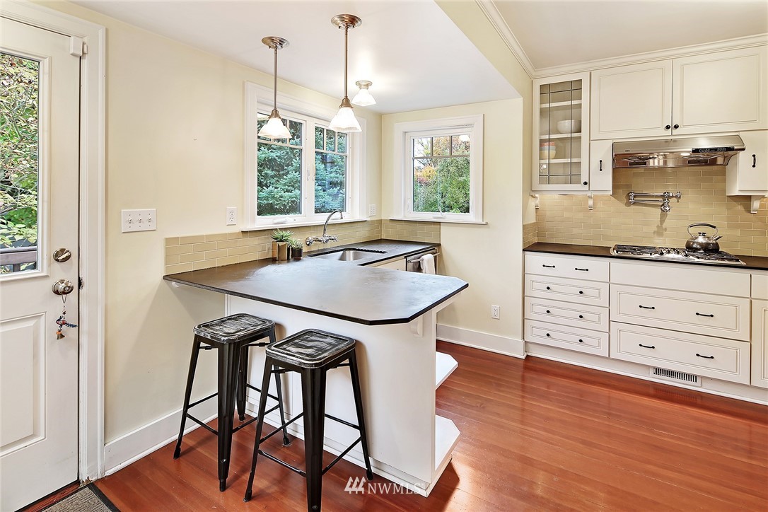 1039 Northeast 91st Street Seattle, WA 98115 - Photo 6 of 25 a kitchen with a table chairs and wooden floor