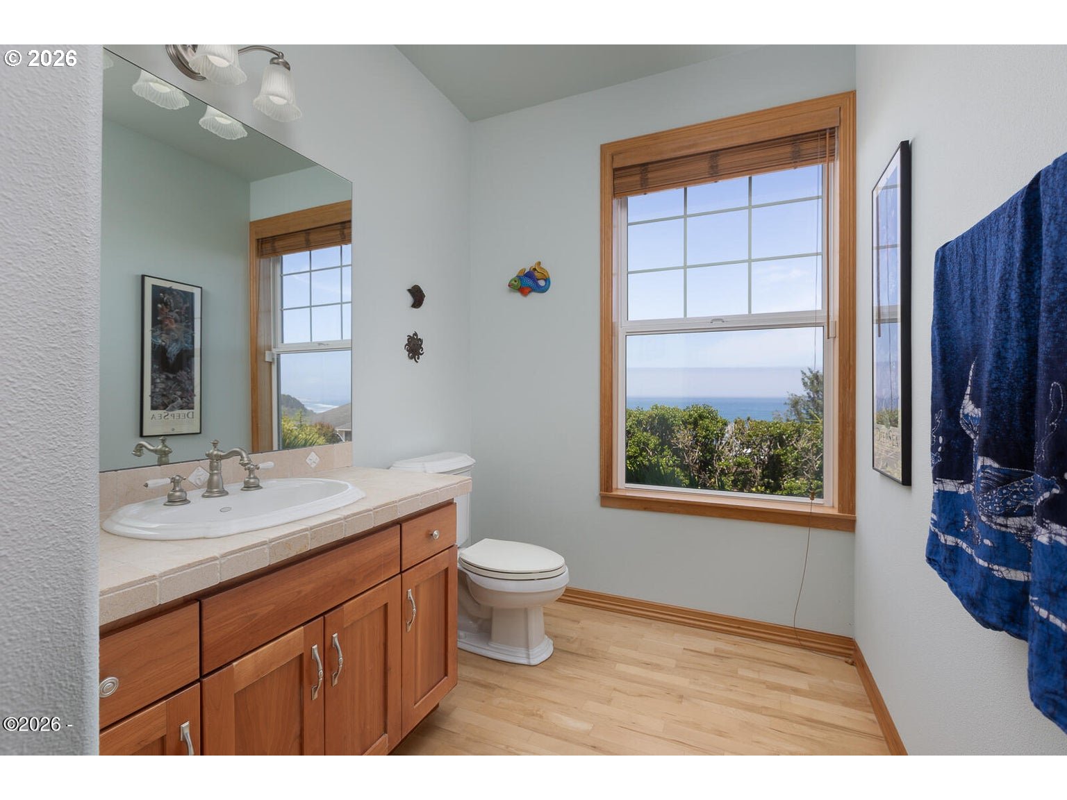5340 Haystack Drive Neskowin, OR 97149 - Photo 34 of 48 a bathroom with a granite countertop sink a large mirror a toilet and a window