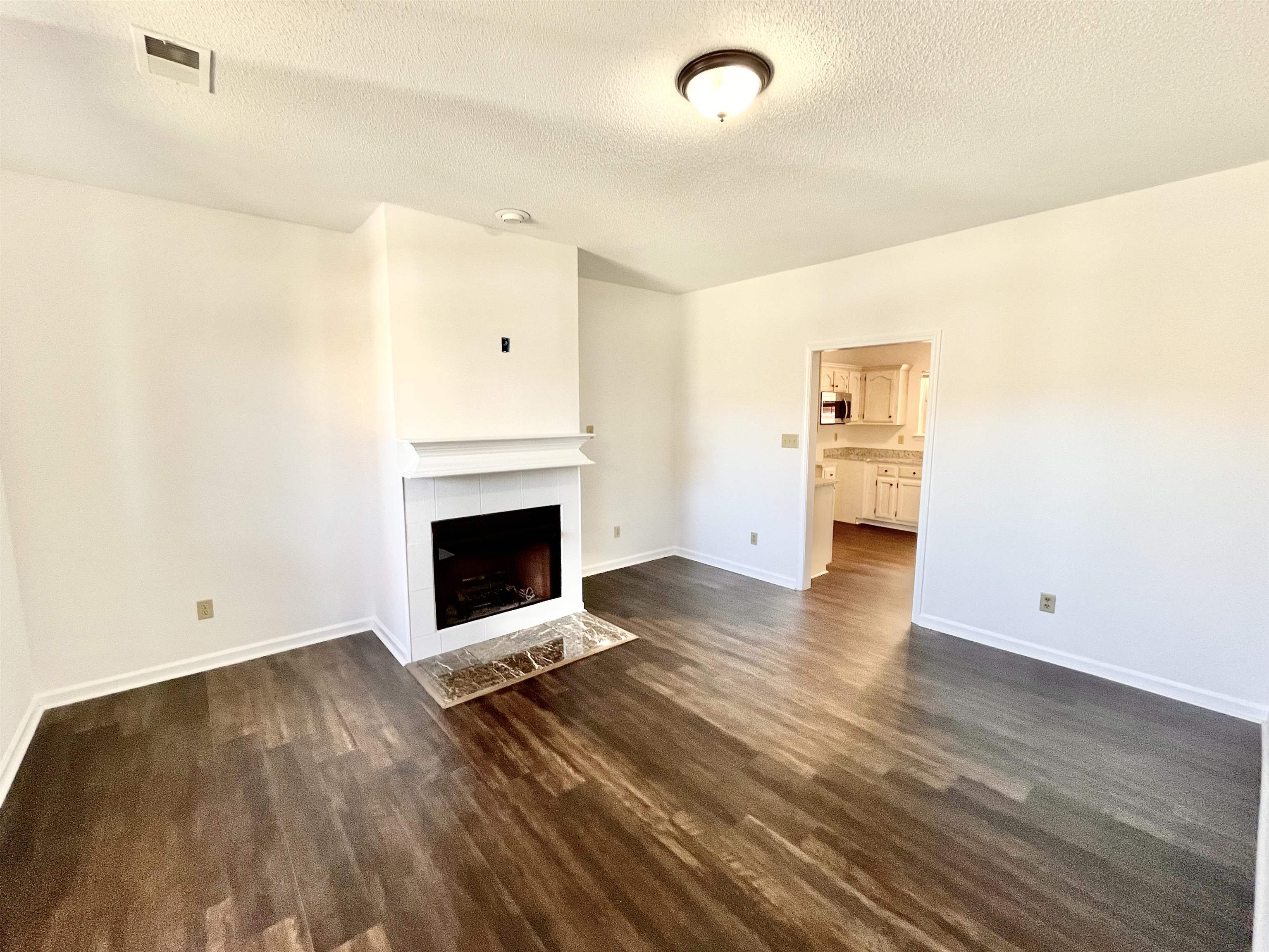 4769 Gilbert Road Memphis, TN 38116 - Photo 21 of 29 a view of a livingroom with a fireplace a fireplace and wooden floor