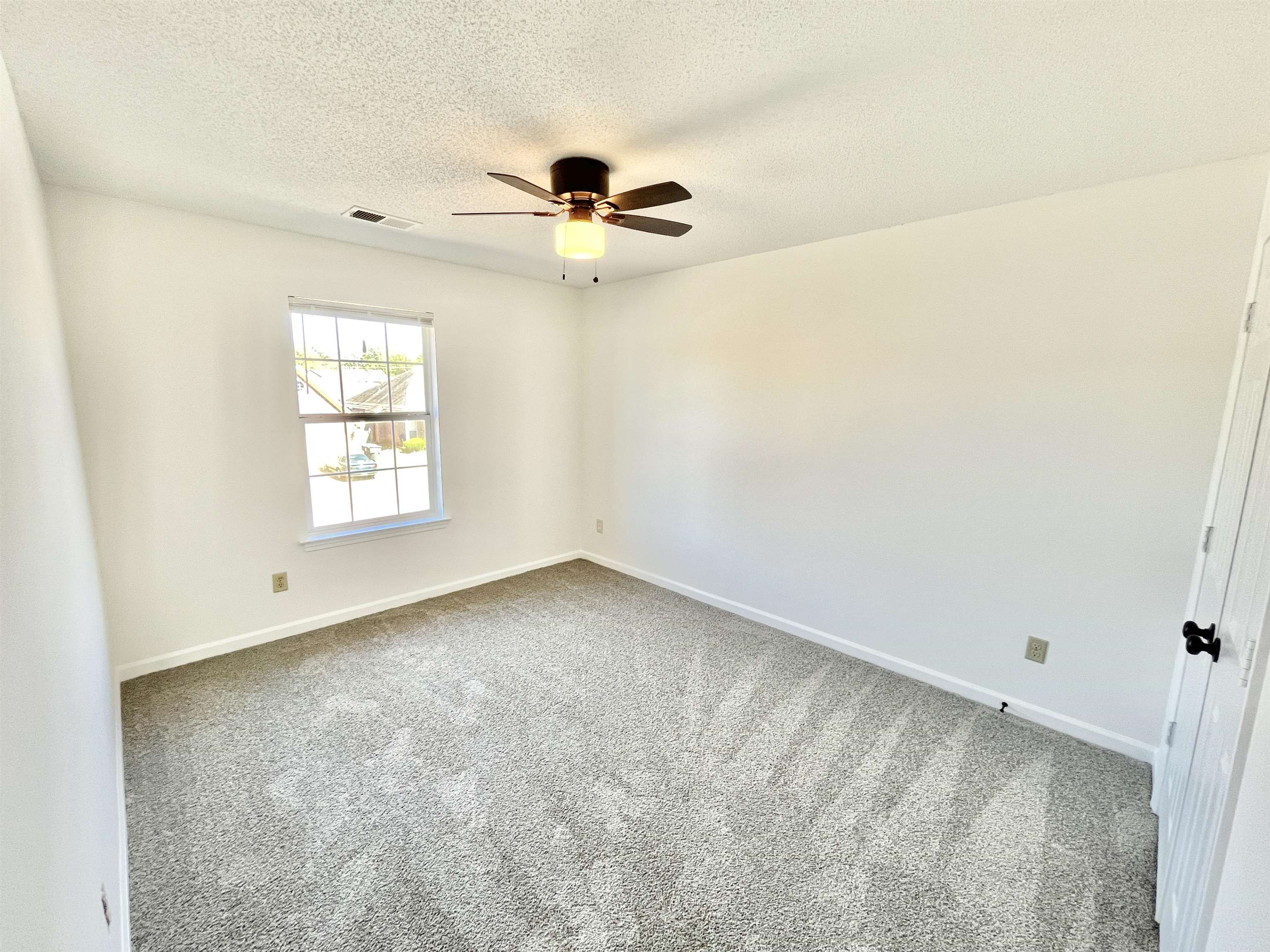 4769 Gilbert Road Memphis, TN 38116 - Photo 8 of 29 an empty room with windows and fan