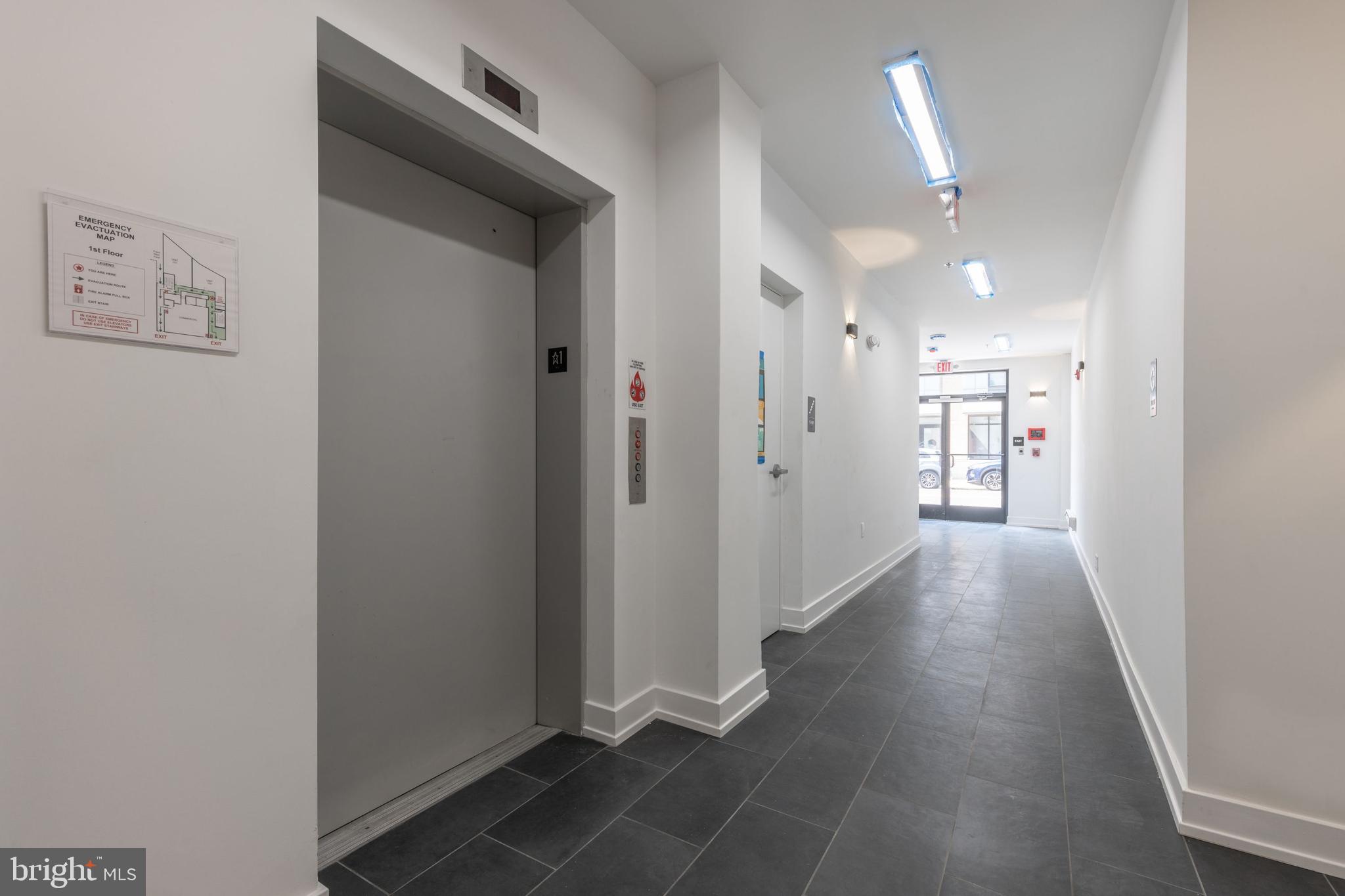 1519 Ridge Avenue, Unit 503 Philadelphia, PA 19130 - Photo 36 of 40 a view of a hallway with wooden floor and a bathroom