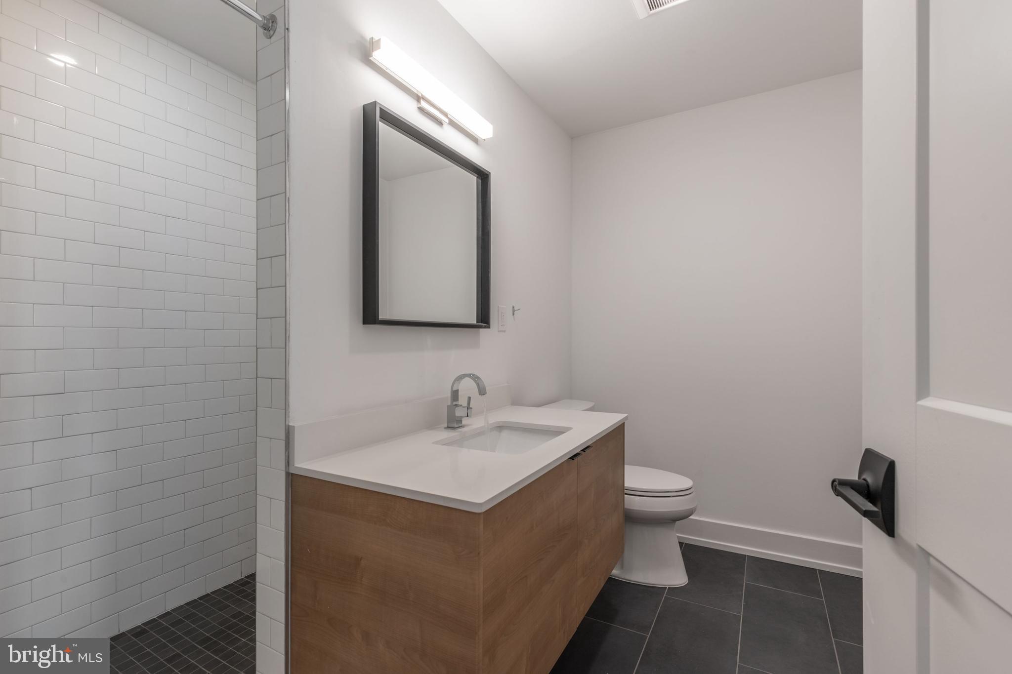 1519 Ridge Avenue, Unit 503 Philadelphia, PA 19130 - Photo 37 of 40 a bathroom with a toilet sink and mirror