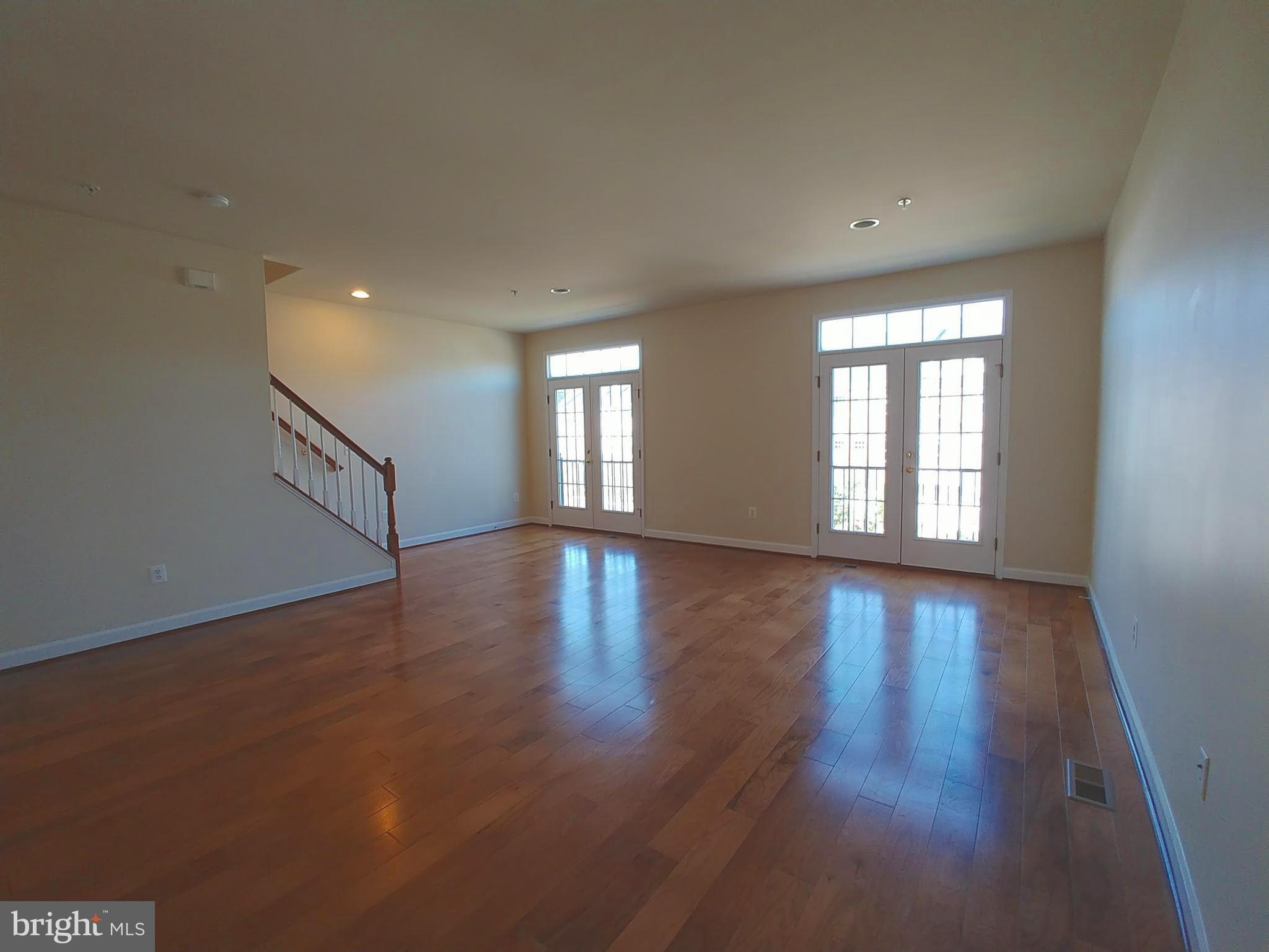 8007 Sport View Road Landover, MD 20785 - Photo 5 of 12 a view of an empty room with wooden floor and fan
