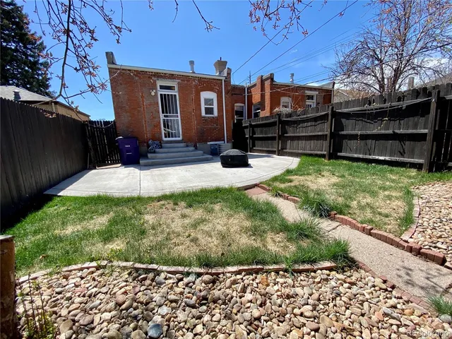 a view of a backyard with wooden fence