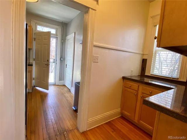 a view of an entryway with wooden floor