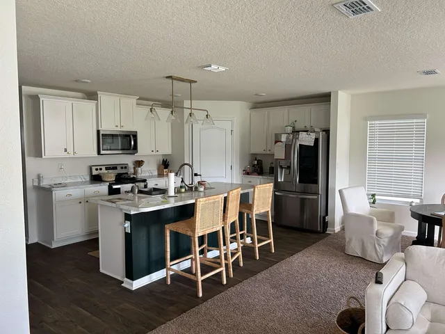 a kitchen with a sink cabinets and stainless steel appliances