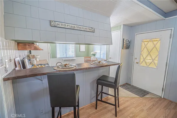 a dining room with furniture and wooden floor