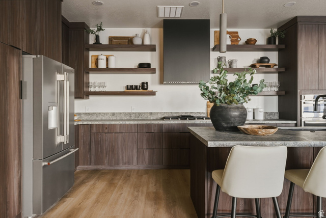 923 North Emery Lane Elk Ridge, UT 84651 - Photo 55 of 101 Contemporary kitchen featuring wood-finish cabinetry, stainless steel refrigerator, dark range hood, and open shelving